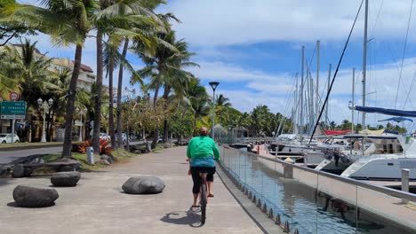 woman cycling along a scenic path by the marina