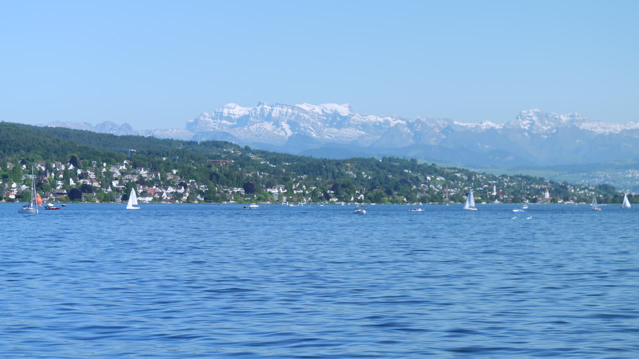 Sailboats on Lake Zurich with the Swiss Alps Mountains in Background