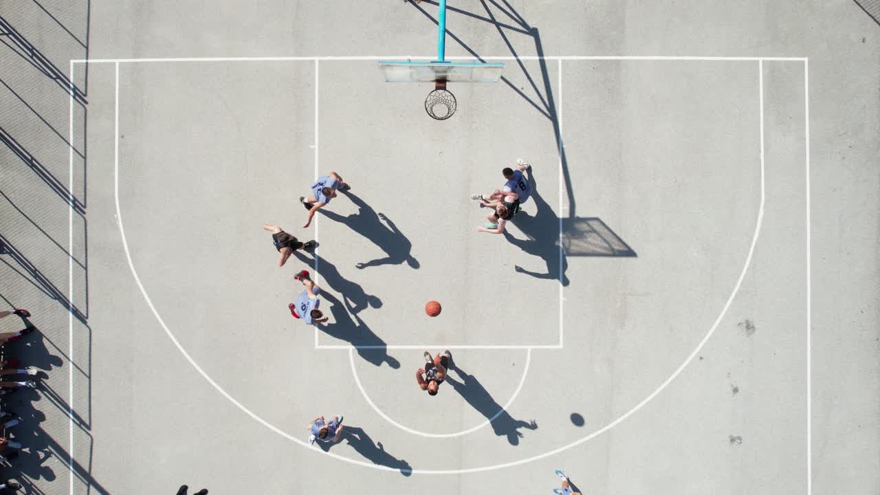Top Down Drone Shot of Men Playing Basketball on Outdoor Court, Shadows and People