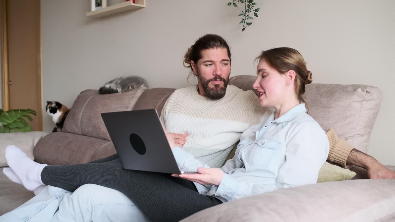 Couple Relaxing at Home with Laptop