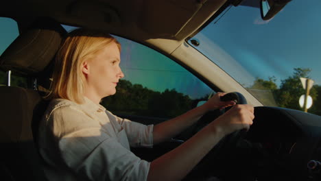 middle-aged female driver drives car in setting sun 5