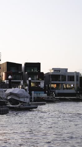 boat cruising through a marina at sunset