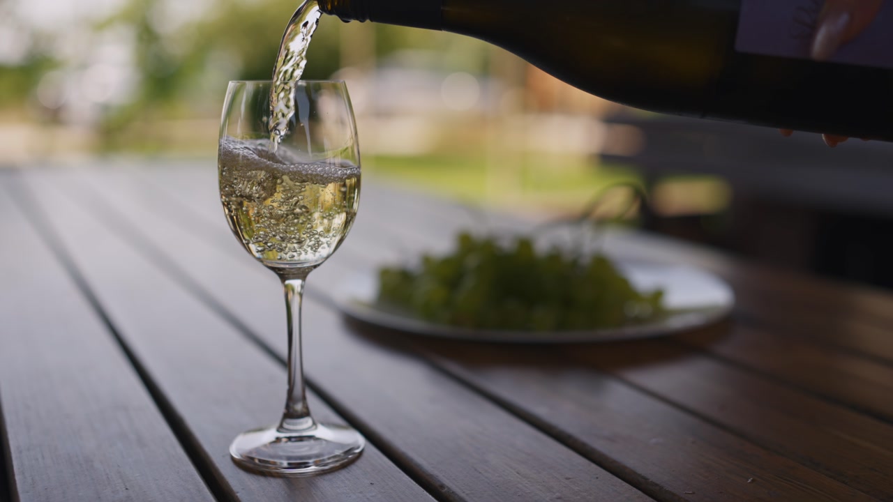 Pouring White Wine Into Glass Outdoor Summer Lifestyle Slowmontion