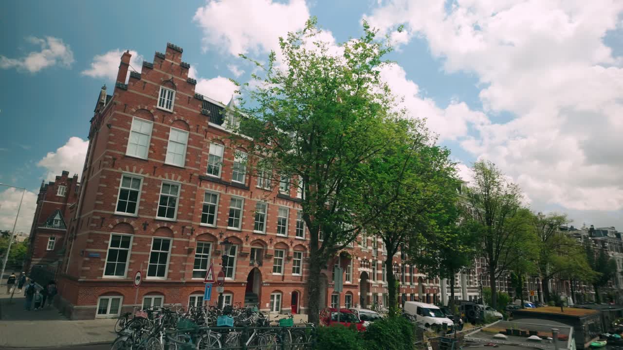 Couple taking a selfie in Amsterdam with traditional canal houses