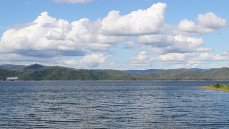 clouds moving over a tranquil lake landscape