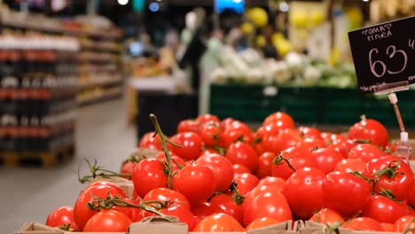 the girl buys tomatoes in the supermarket, natural products, food for vegans