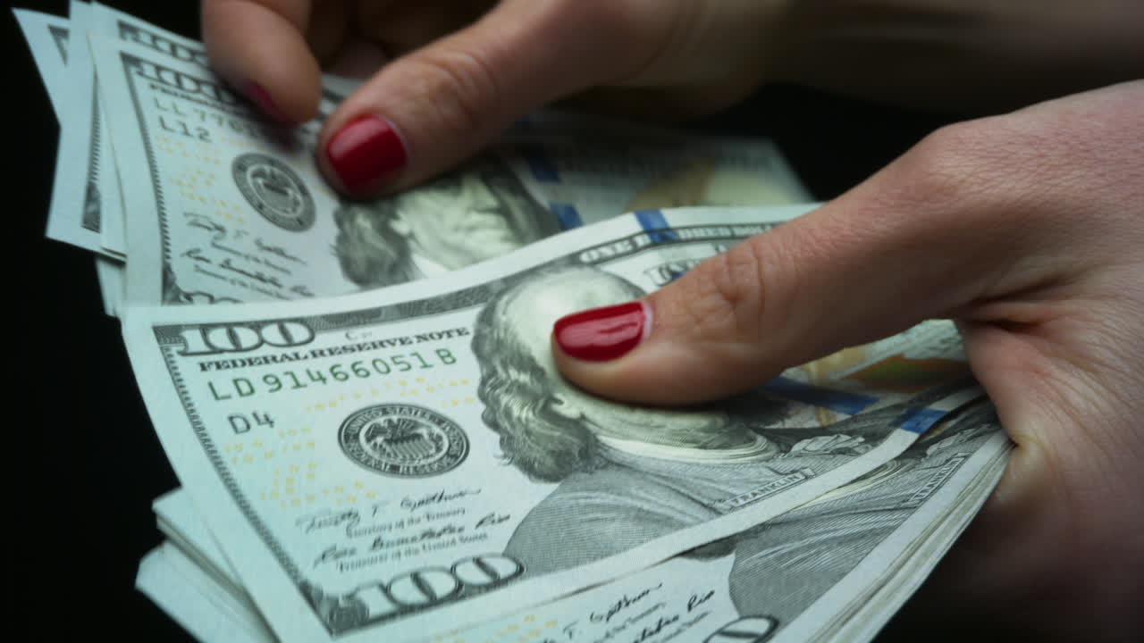 Woman checking amount of cash money. Hands holding one hundred dollar bills