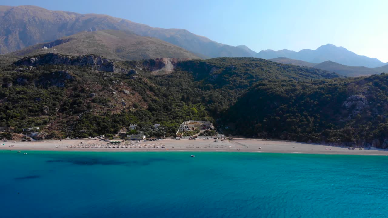 Beautiful panoramic seaside seen from blue azure sea water with Albanian mountains background