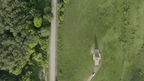 high angle tilt down shot of the kojori woods, road and the st