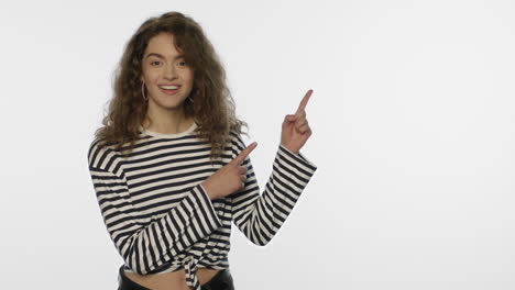 young woman advertising product with hand gesture on white background