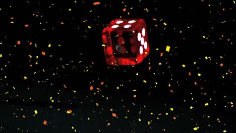 confetti falling over red casino dice falling against black background