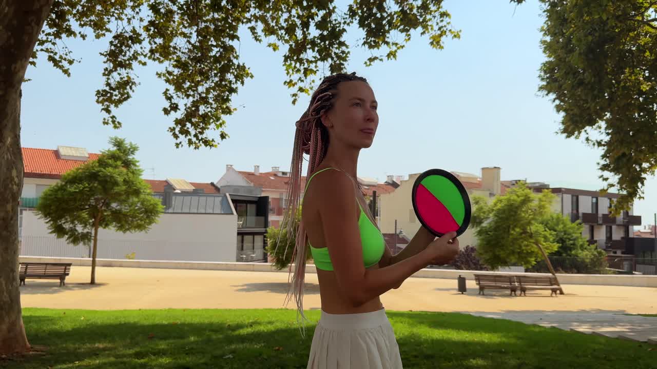 Woman playing paddle ball in the park