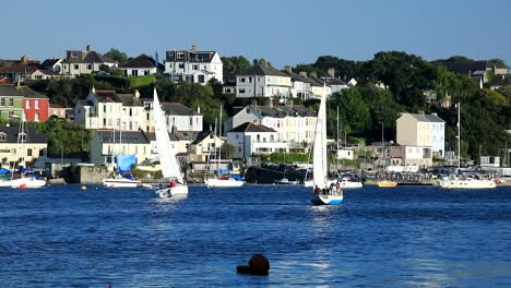 two sailboats compete along the river tamar on a summers day between devon and cornwall