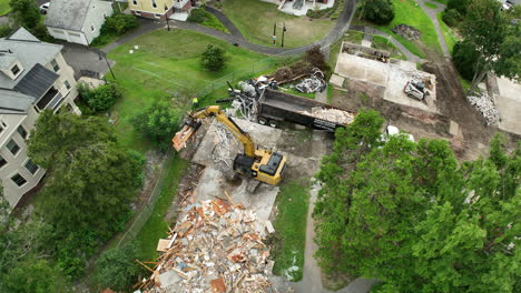 head shot of demolition of a building with bulldozer