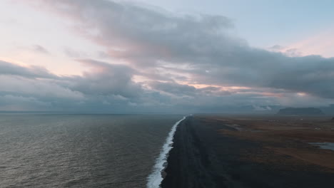static aerial slow motion clip of black sand shoreline in iceland