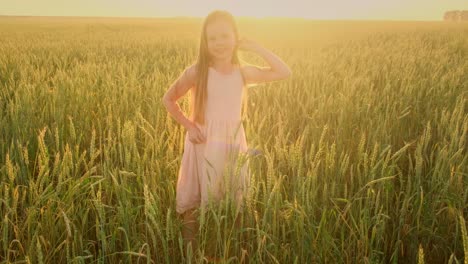 happy girl jumping in a wheat field at sunset
