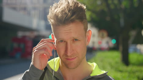 Portrait-of-active-young-man-listening-to-music