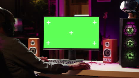 mockup display used by man playing on pc, using headphones to talk