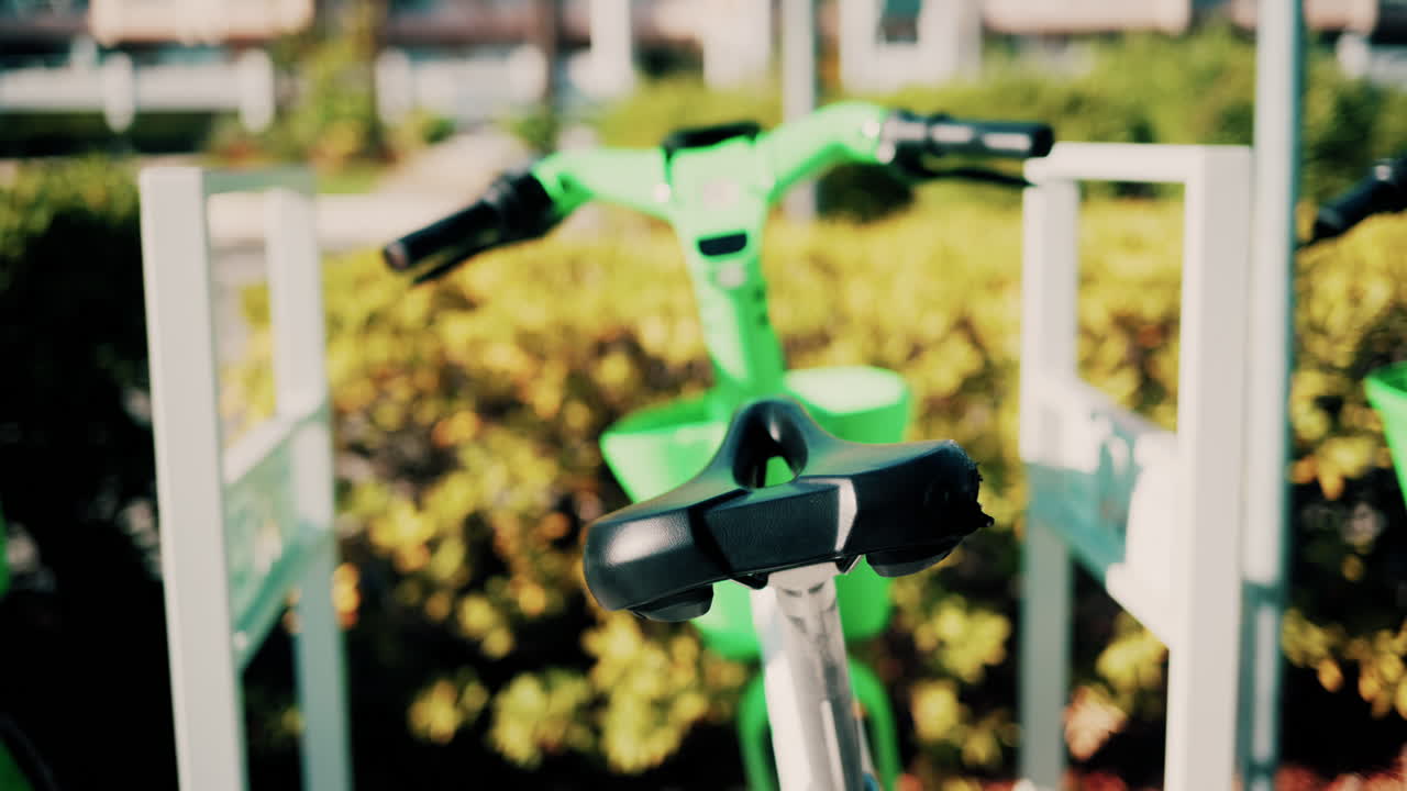 Close up of a green electric bicycle with modern design, parked outdoors under natural light