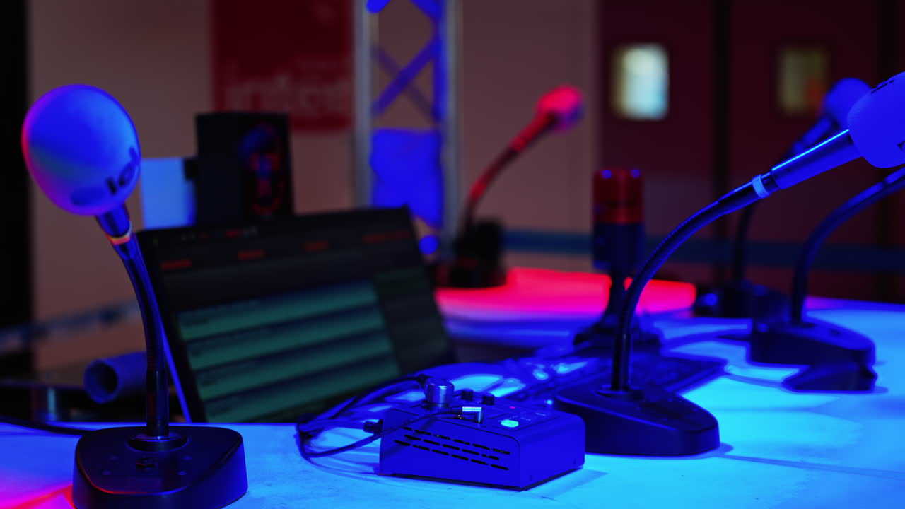 Cannes, France - March 2, 2025: Close up of a microphone on a blurred background with blue and red lights at the International Games Festival