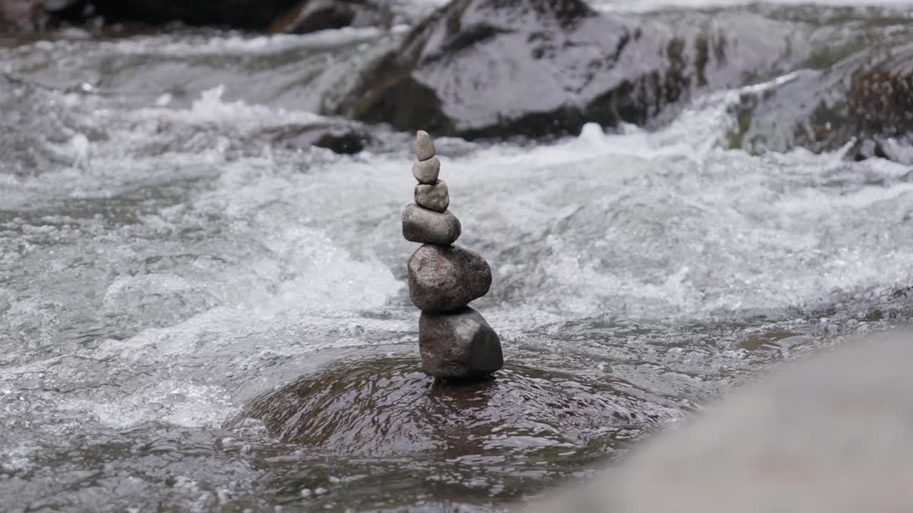 Rock Cairn, Pile Of Stones Stacked On Top Of Each Other On Rocky River, Slow Motion