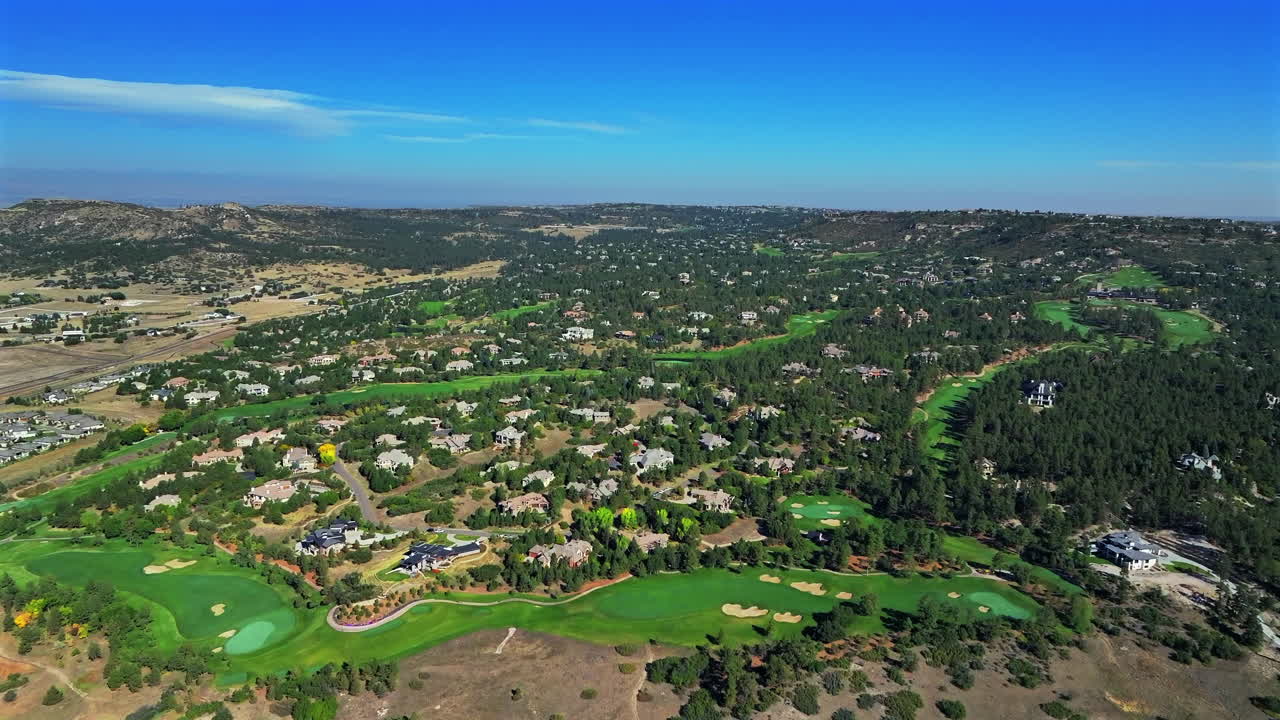 Daniels Park Castle Pines Village North Ridge Golf Course spring summer aerial drone Denver Colorado front range sunrise morning i25 Highlands Ranch Park Meadows homes green grass forward pan up