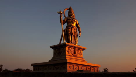 golden hanuman statue at sunset