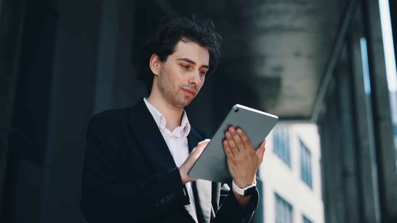 Young Businessman Using a Tablet Outdoors