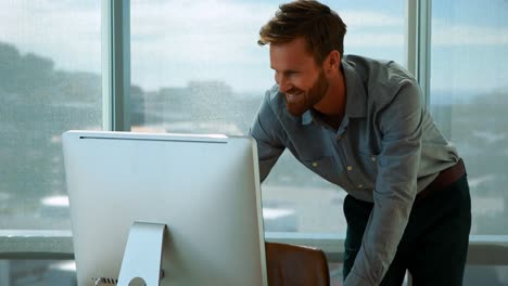 Male executive working over computer at his desk
