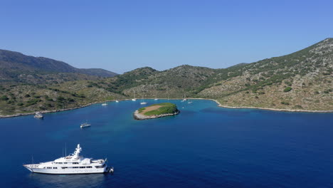 aerial: flying towards paradise bay of the island of kira panagia in sporades, greece with amazing turquoise and emerald crystal clear sea