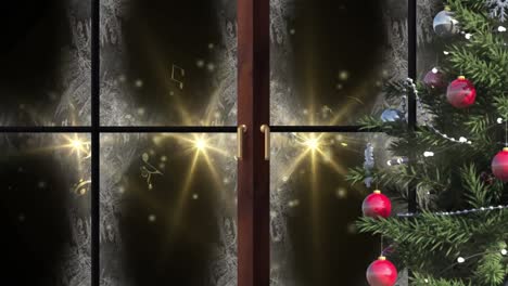 Christmas-tree-and-wooden-window-frame-against-golden-spots-of-light-on-black-background