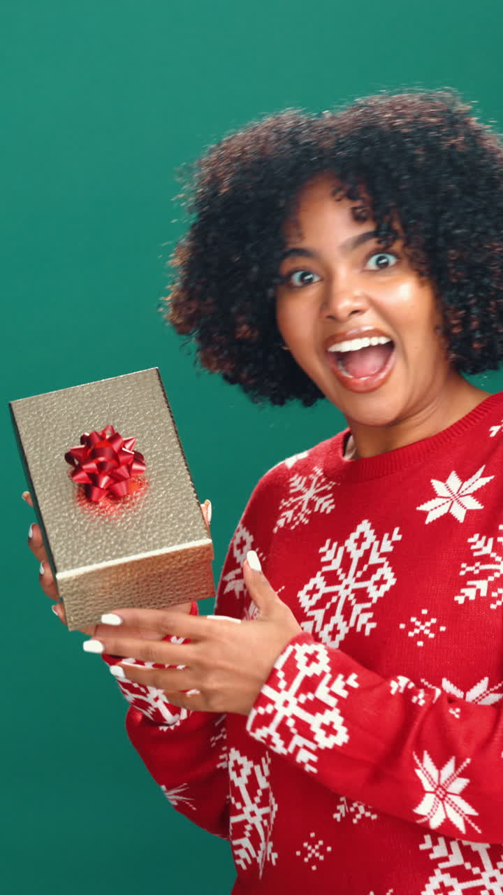 Curious Woman Shakes Christmas Gift Box with Surprise and Joy