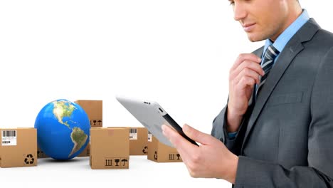 Animation-of-businessman-using-tablet-with-stacks-of-boxes-and-globe-on-white-background