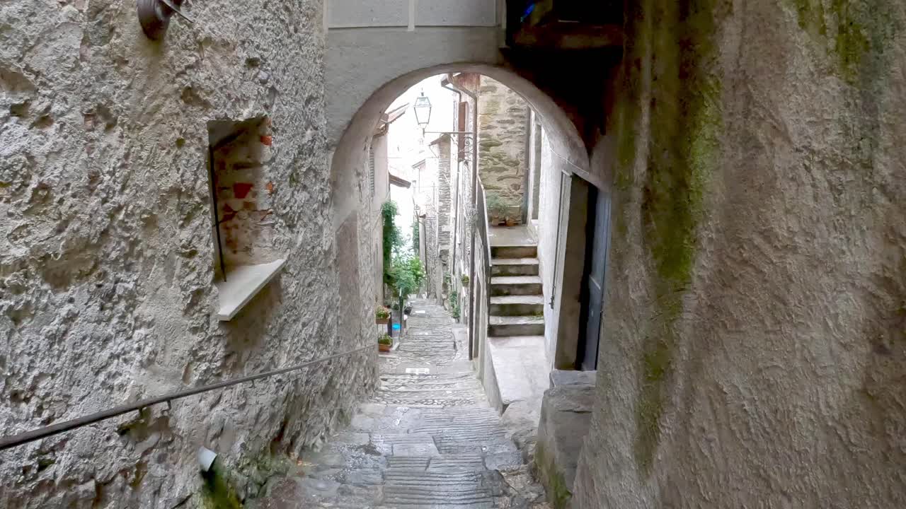 Walking down the steps in the ancient village of Corenno Plinio on the shore of Lake Como, Italy