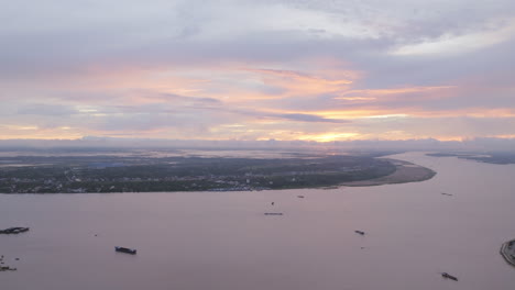 aerial video of phnom penh shows the mekong river bending through the landscape at sunset