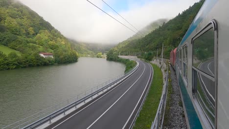 Passenger-train-along-Sava-river-in-Slovenia,-onboard-camera