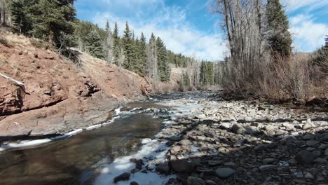 fpv 4k drone under bridge in rocky mountains