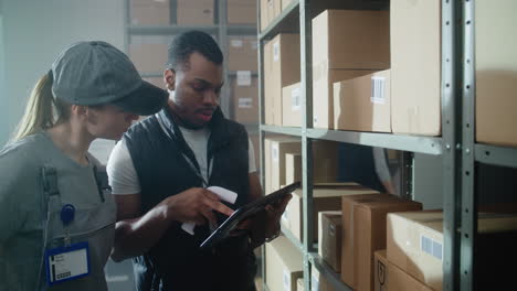 warehouse workers checking inventory with tablet