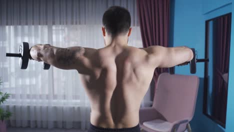 man working hard to isolate his dynamic sports body. bodybuilding at home.