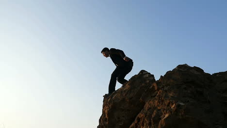 man jumping from a cliff