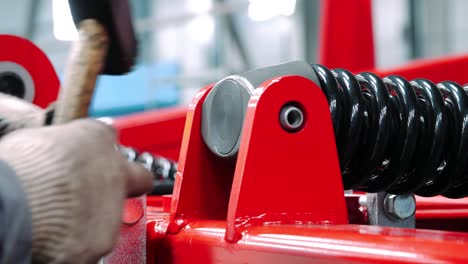 machine shop worker inserting sleeve into shock absorber. manual assembly