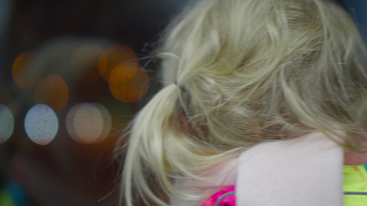 niño mirando la ciudad nocturna desde la ventana del tren