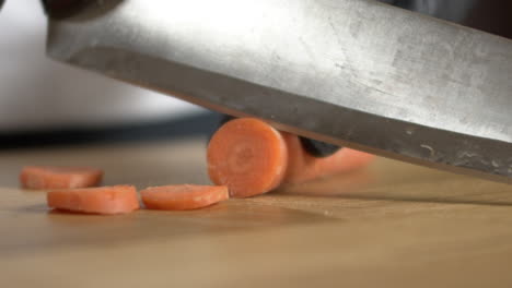 chef slices a carrot, apple prores slow-mo