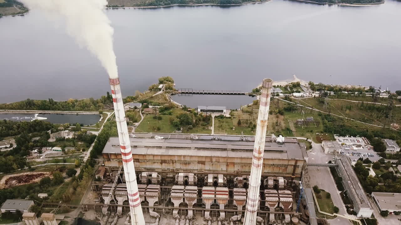 Aerial view of coal power station with smoke goes from tubes. View from the birds-eye view.