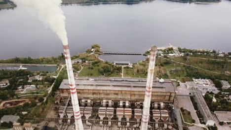 aerial view of coal power station with smoke goes from tubes. view from the birds-eye view.