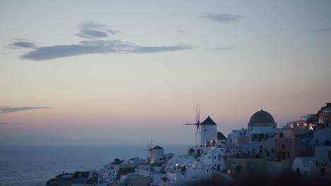 oia cliffside sunset view in santorini, greece