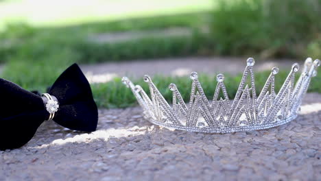 silver wedding crown and groom bow tie on the rock in the garden - fixed camera