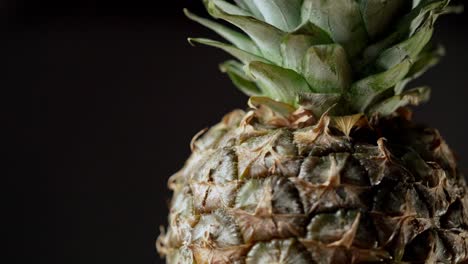 isolated pineapple fruit on black background rotating through the screen