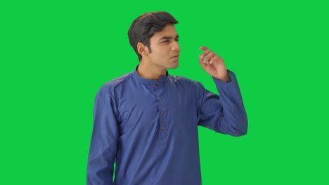 confused young indian man thinking green screen