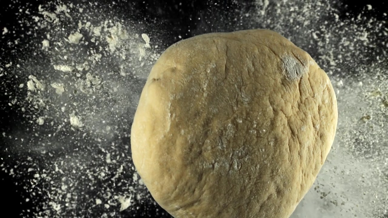 Flour Falling on Fresh Dough in Slow Motion